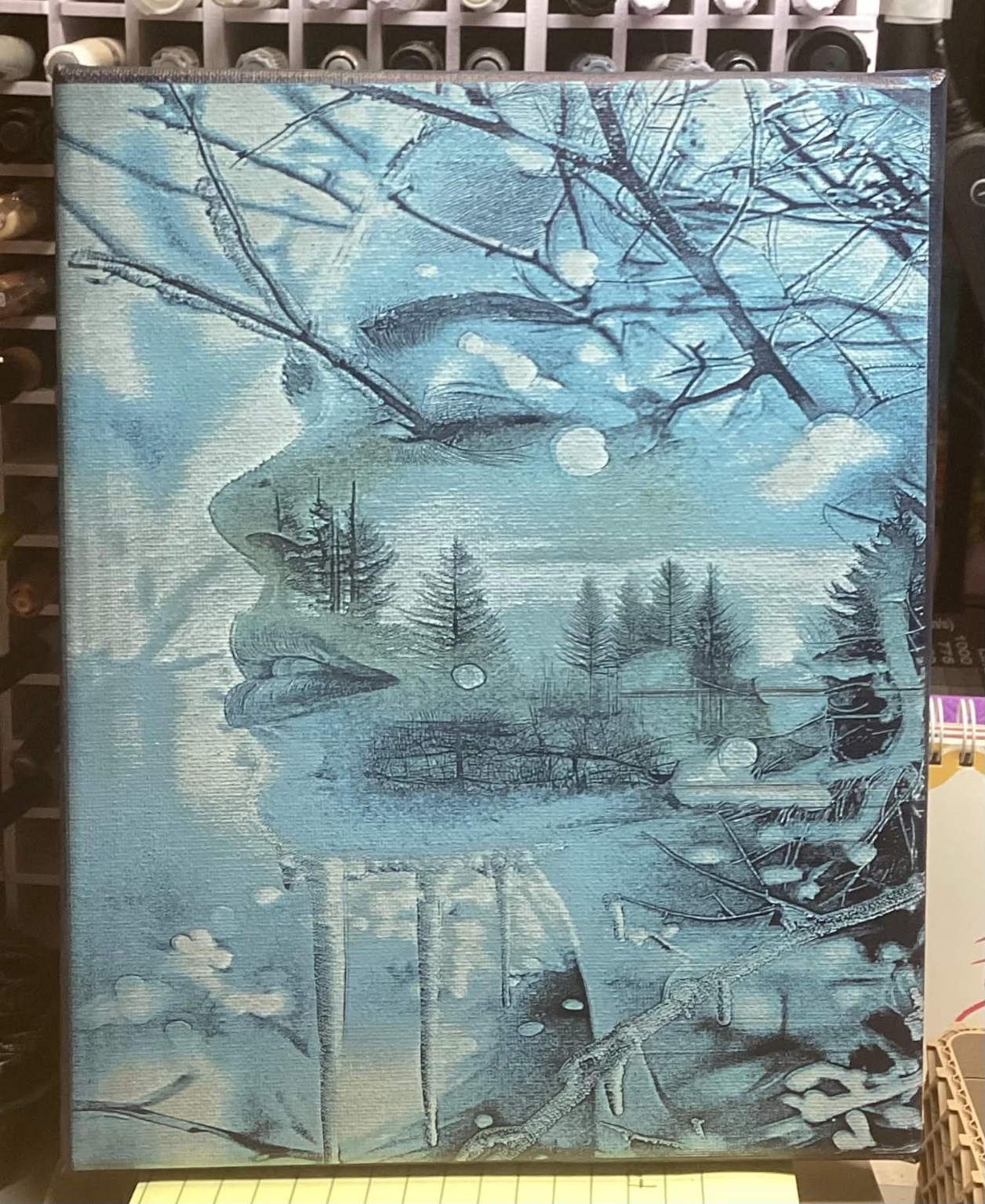 Blue-toned engraved woodland landscape on wood