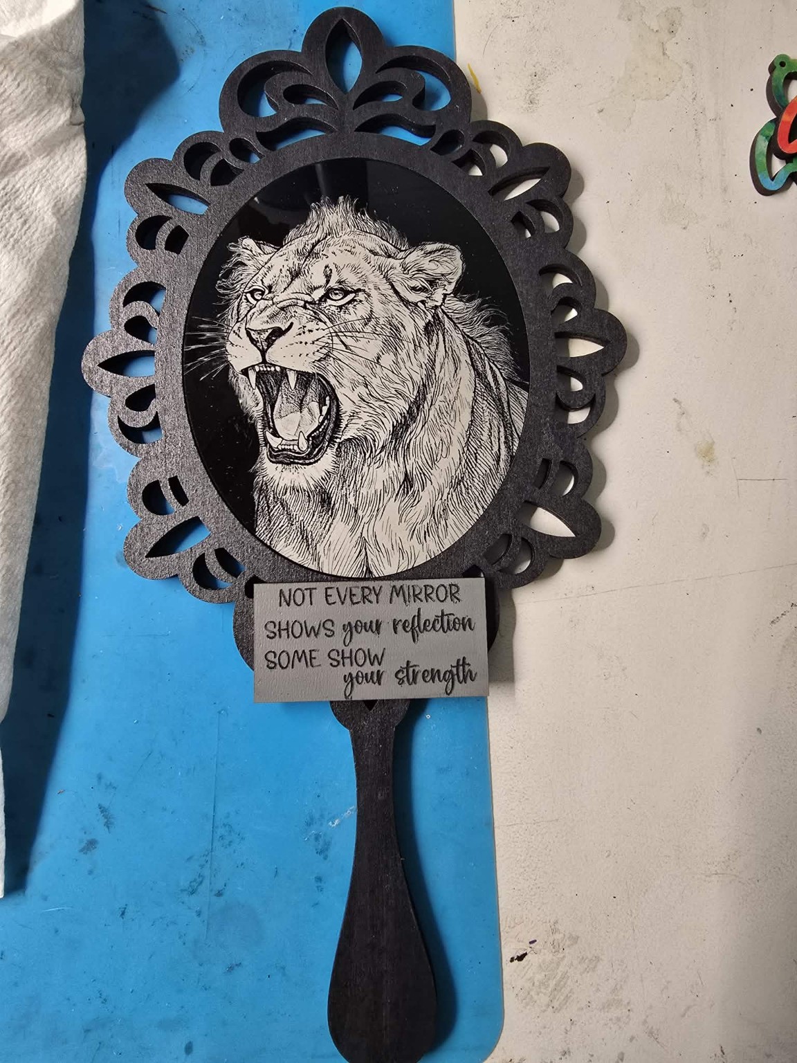 Framed lion artwork engraved on wood