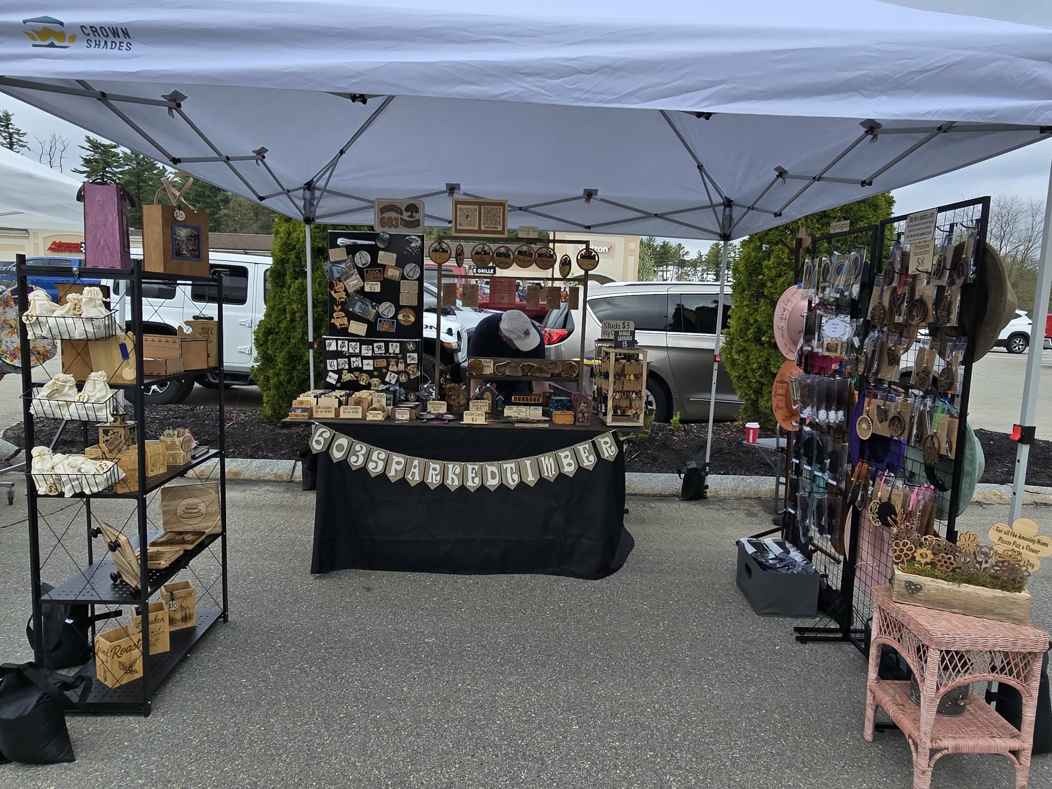 Wide view of the 603SparkedTimber market booth under a canopy