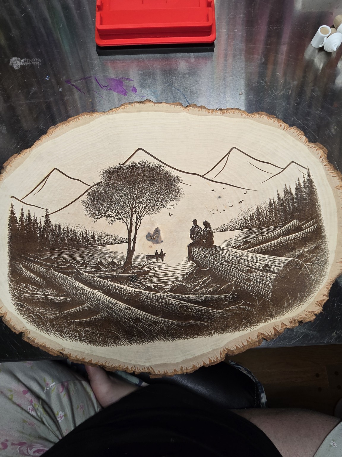 Round wood engraving of a mountain landscape