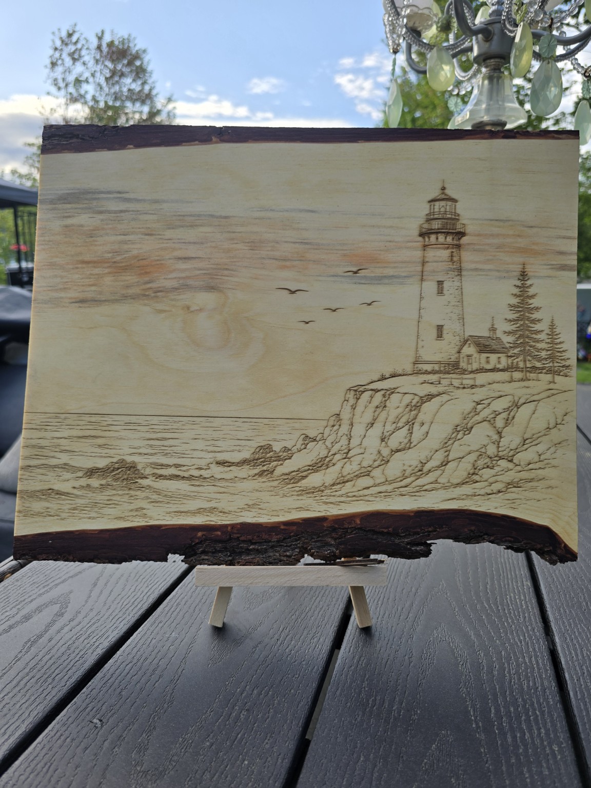 Engraved sailboat scene on wood